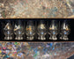 Set of six glass tumblers with Game Bird designs in a black box on a textured surface.