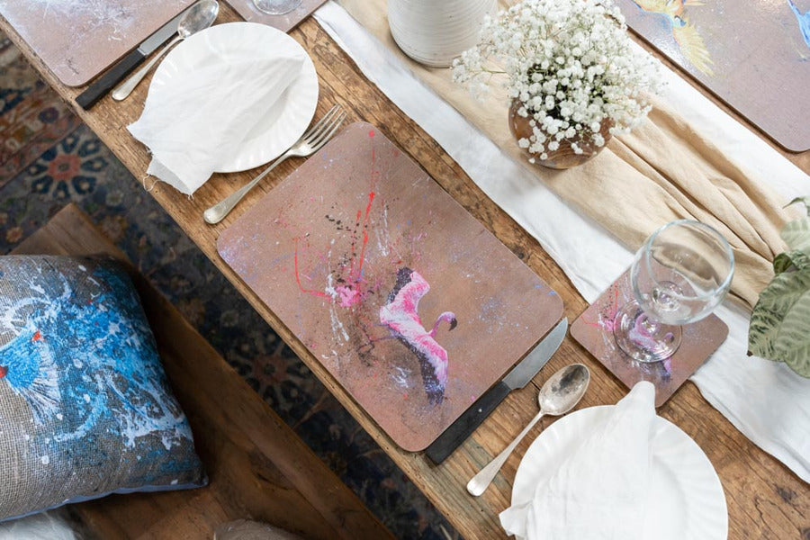 Each placemat features a different bird illustration, making the set playful, artistic, and perfect for entertaining.