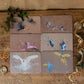 Boxed set of 6 artist-designed bird placemats - each featuring a unique hand-painted bird artwork.
